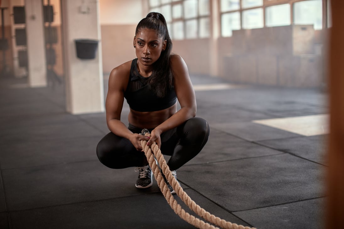 Fit Woman Working Out with Ropes at the Gym 